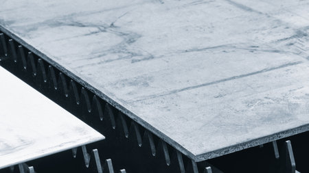 metal sheet is placed on the surface. plate is made of metal and has a rough texture. It is placed on the black cutting tabletopの写真素材