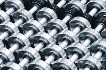 On the table there is a row of metal cylinders of rollers for industrial conveyor, industrial...