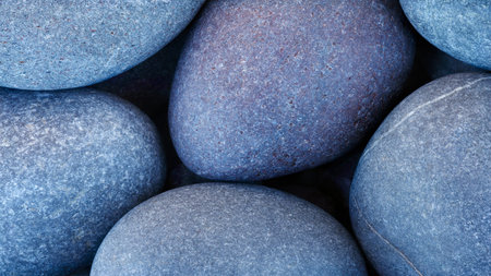 Group of beautiful blue round pebble stones close-up as textured abstract SPA background for web...