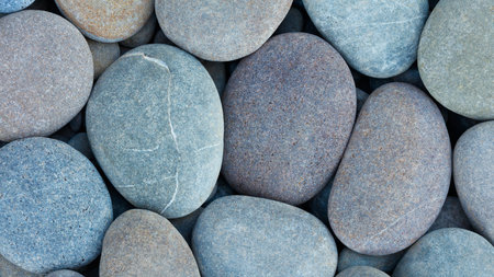 Pebbles stones on seashore as texture background for design web banner template page. many stones...