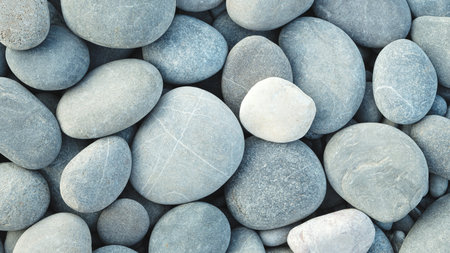 Pebbles stones on seashore as texture background for design of web banner template page. many stones...
