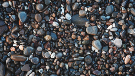 A collection of wet, smooth, multicolored sea stones. The concept of tranquility and serenity serves...