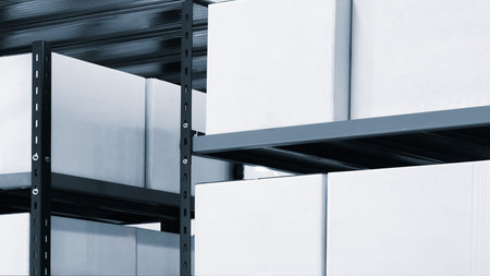 Row of white boxes on a shelf dividers. boxes are stacked on top of each other.