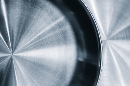 Silver frying pan with black rim. The frying pan is shiny and has a smooth surface as an abstract metallic texture background for web banner template page designの写真素材