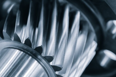 Close-up of gear with many details. gear silver with many diagonal teeth, against an industrial...