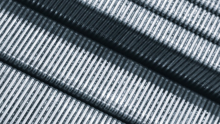 Close-up of long mounting brackets assembled for loading into an industrial packaging machine