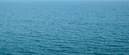 Wide panorama of blue clear sea water surface as background for web banner template page design or...