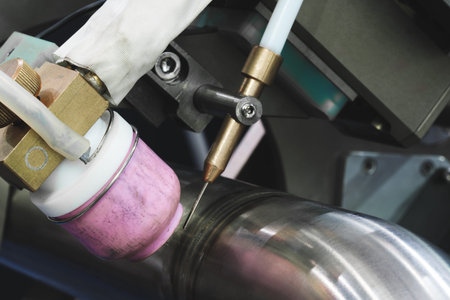 Modern automatic welding machine for welding metal pipes, industrial welding concept background