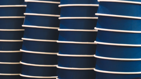 Deep blue paper cups are stacked and ready to be used for selling juice, water, coffee or other drinks.の写真素材