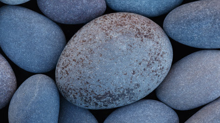 Pebbles stones on seashore as texture background for design web banner template page. SPA concept background.の写真素材