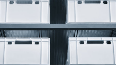 Row of white boxes on a shelf dividers. boxes are stacked on top of each other.の写真素材
