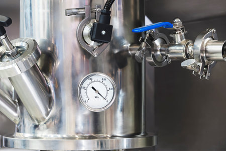 Industrial water supply gas supply machine with metal pipes and pressure gauges in industrial...