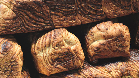 Pile of rye bread. bread is made from flour and has slightly burnt, appetizing appearance. bread is...