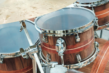 Several drums with wooden bodies and silver rims. Musical percussion instruments concept
