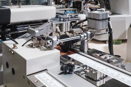 Machines for cutting, sewing and embroidering patterns in textile factory.
