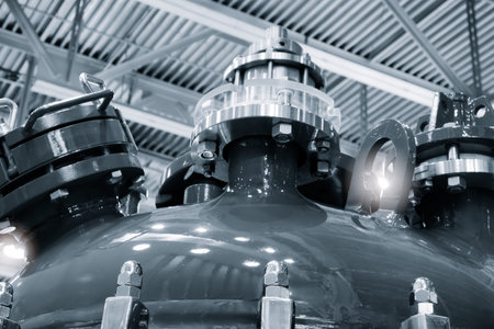 Industrial medicine production machine in pharmaceutical factory with many shiny stainless steel parts as industrial concept backgroundの写真素材