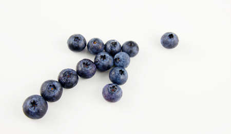 Fresh blueberries in a shape of an arrow isolated on white backgroundの写真素材