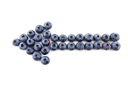 Arrow made of blueberries isolated on whiteの写真素材