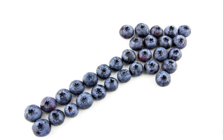 Arrow made of blueberries isolated on whiteの写真素材