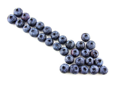 Arrow made of blueberries isolated on whiteの写真素材