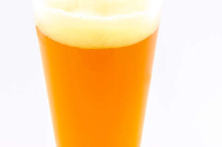 Glass of beer closeup isolated on a white background の写真素材