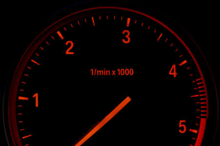 Diesel car tachometer isolated on black backgroundの写真素材