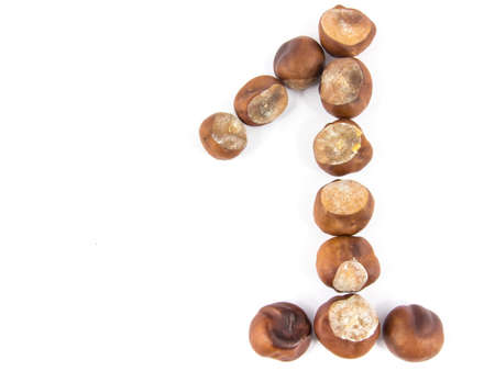 First place concept made of chestnuts isolated on white backgroundの写真素材