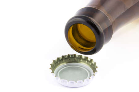 Open beer bottle and a cap isolated on white backgroundの写真素材