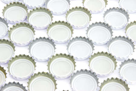 Background of used beer caps over white の写真素材