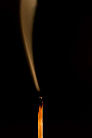 Silhouette of an extinguished match flameの写真素材