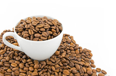 Cup filled with coffee beans isolated on white backgroundの写真素材
