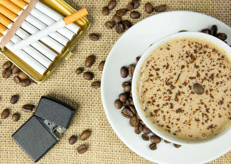 Aerial view of cup of coffee, lighter and cigarettesの写真素材