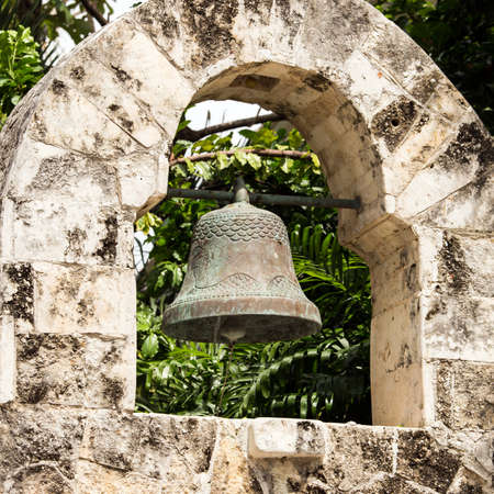 Antique wrought iron bell in mexican village of Playa del Carmenの写真素材