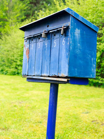 Old blue mailbox on a stake somewhere  in the countryの写真素材