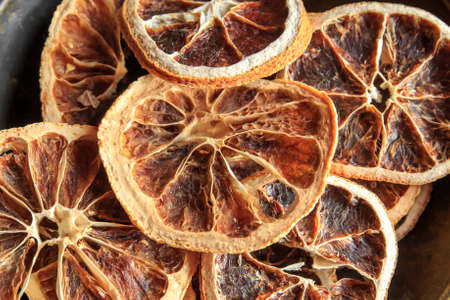 Closeup of dried orange slices on black platterの写真素材