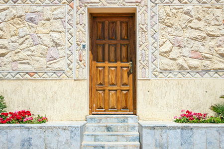 Closed brown wooden door and and stone steps