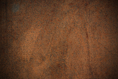 Piece of brown leather closeup for background or texture