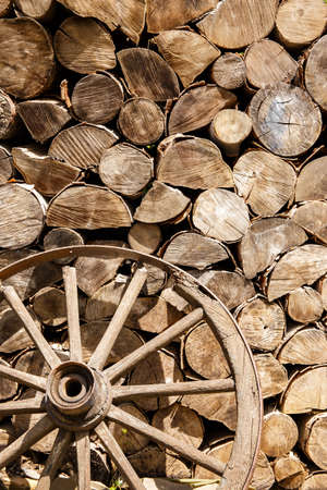Heap of firewood and old broken wheel somewhere in the countryの写真素材