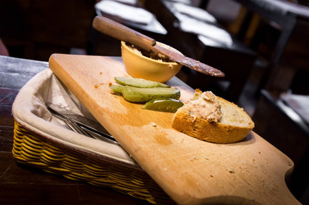 Traditional polish lard on a slice of bread and pickled cucumbers