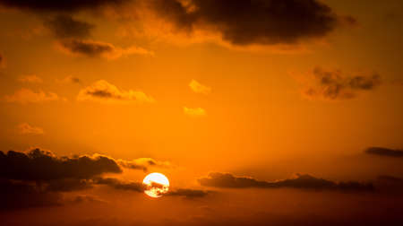 Beautiful sky with golden sunrise and small cloudsの写真素材