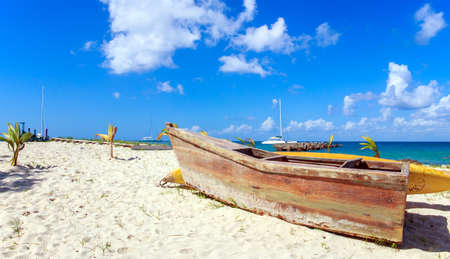 Small wooden boat on caribbean beach in Dominican Republicの写真素材