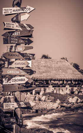 Old signpost with distance and direction to many different countriesの写真素材