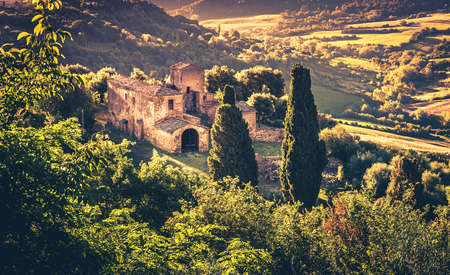 Italian country house on a green hill in Tuscanyの写真素材