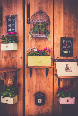Vintage style decoration with decorative flowers on wooden wallの写真素材