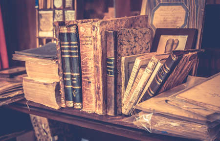 MONTEPULCIANO, ITALY - JUNE 23, 2015: collection of antique books and maps in tuscan antiquarian bookshop in Montepulciano town, Italyのeditorial素材
