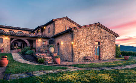 PIENZA, ITALY - JUNE 21, 2015: beautiful renovated tuscan manor at sundown near historic Pienza town in Italyのeditorial素材