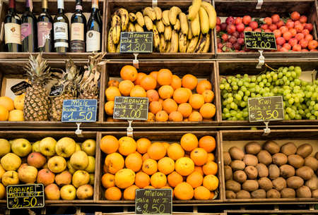 CORTONA, ITALY - JUNE 26, 2015: assortment of toscan ripe fruits and wine bottles in historic Cortona town in Italyのeditorial素材