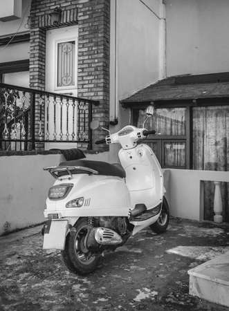 Black and white scene from greek Kos island with scooter in the foregroundの写真素材