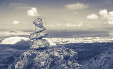 Tower of pebbles and panorama of greek Kos island