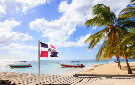 Caribbean beach and Dominican Republic flag on Saona islandの写真素材